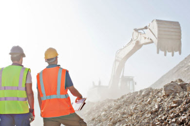 Workers looking at excavator
